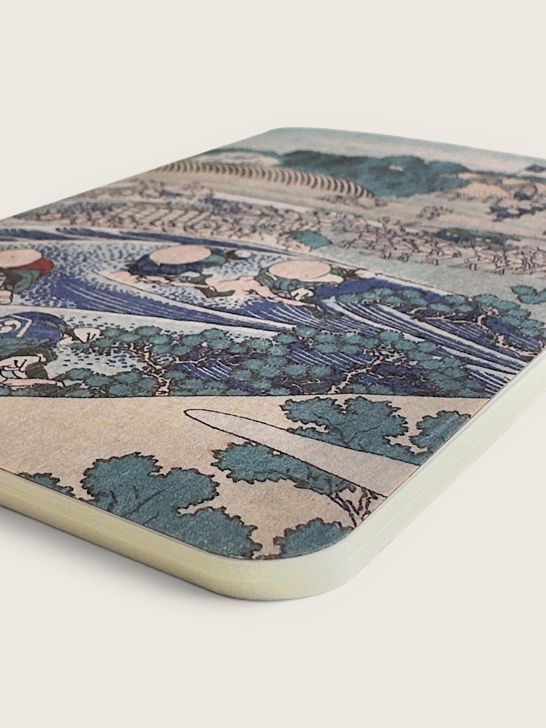 Corner of the Hokusai Tokaido RO-BIKI waxed pocket notebook, showing the woodblock scene printed into the waxed cover.
