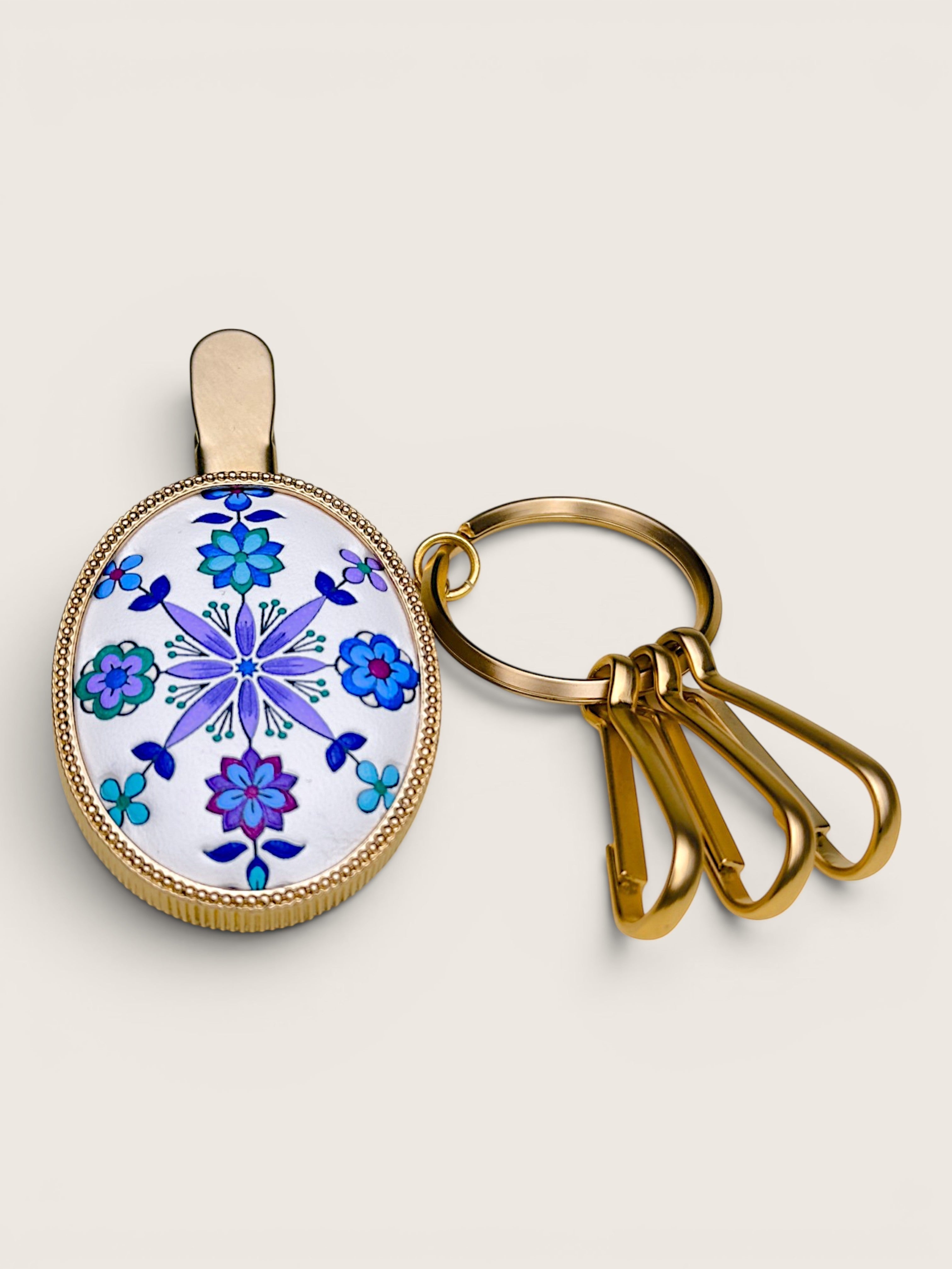 Ourooh Japanese Yuzen leather key clip with blue and violet floral pattern in a brass frame with three key hooks.