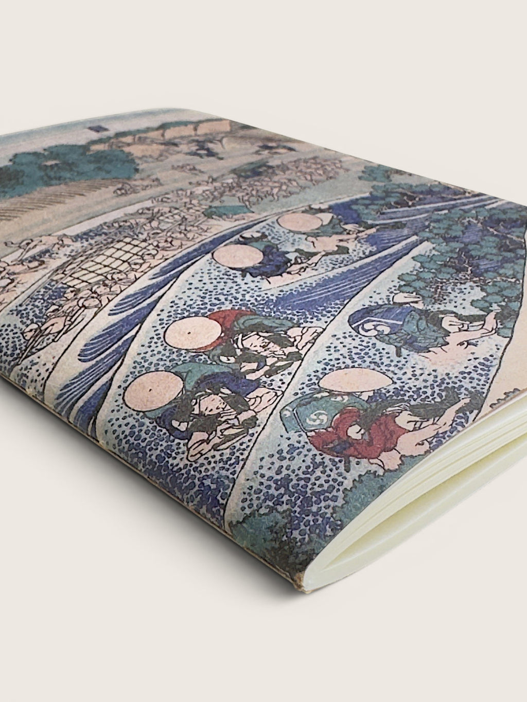 A notebook or journal featuring a detailed Japanese ukiyo-e woodblock print cover, shown at an angle on a light beige background.