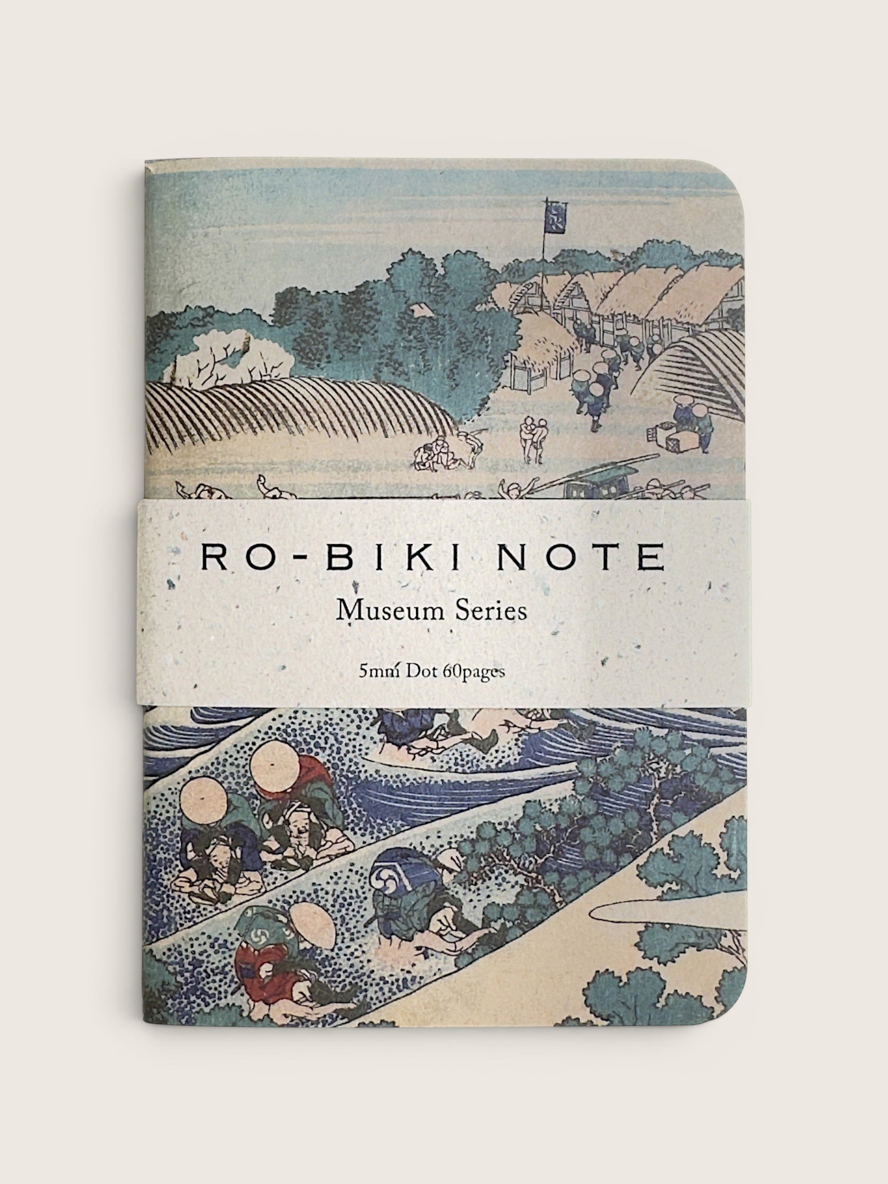 A notebook with a vintage Japanese ukiyo-e woodblock cover design, featuring the text 'RO-BIKI NOTE Museum Series' wrapped around the center, photographed against a neutral light beige background.