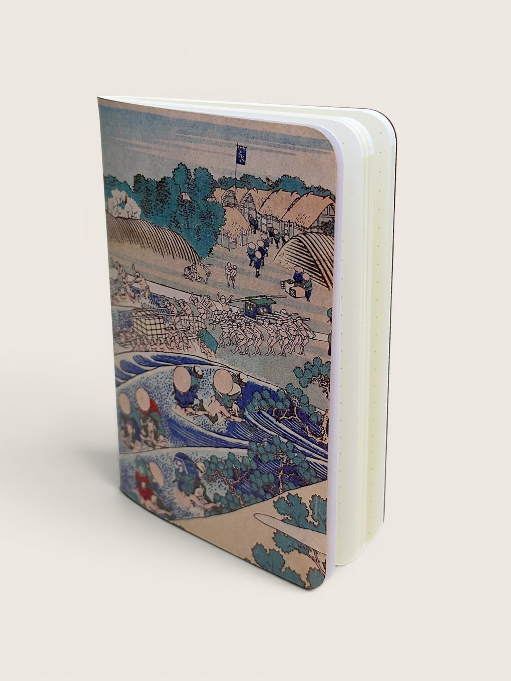 A hardcover notebook featuring a detailed Japanese ukiyo-e woodblock print on the cover, displayed at an angle on a light beige background.