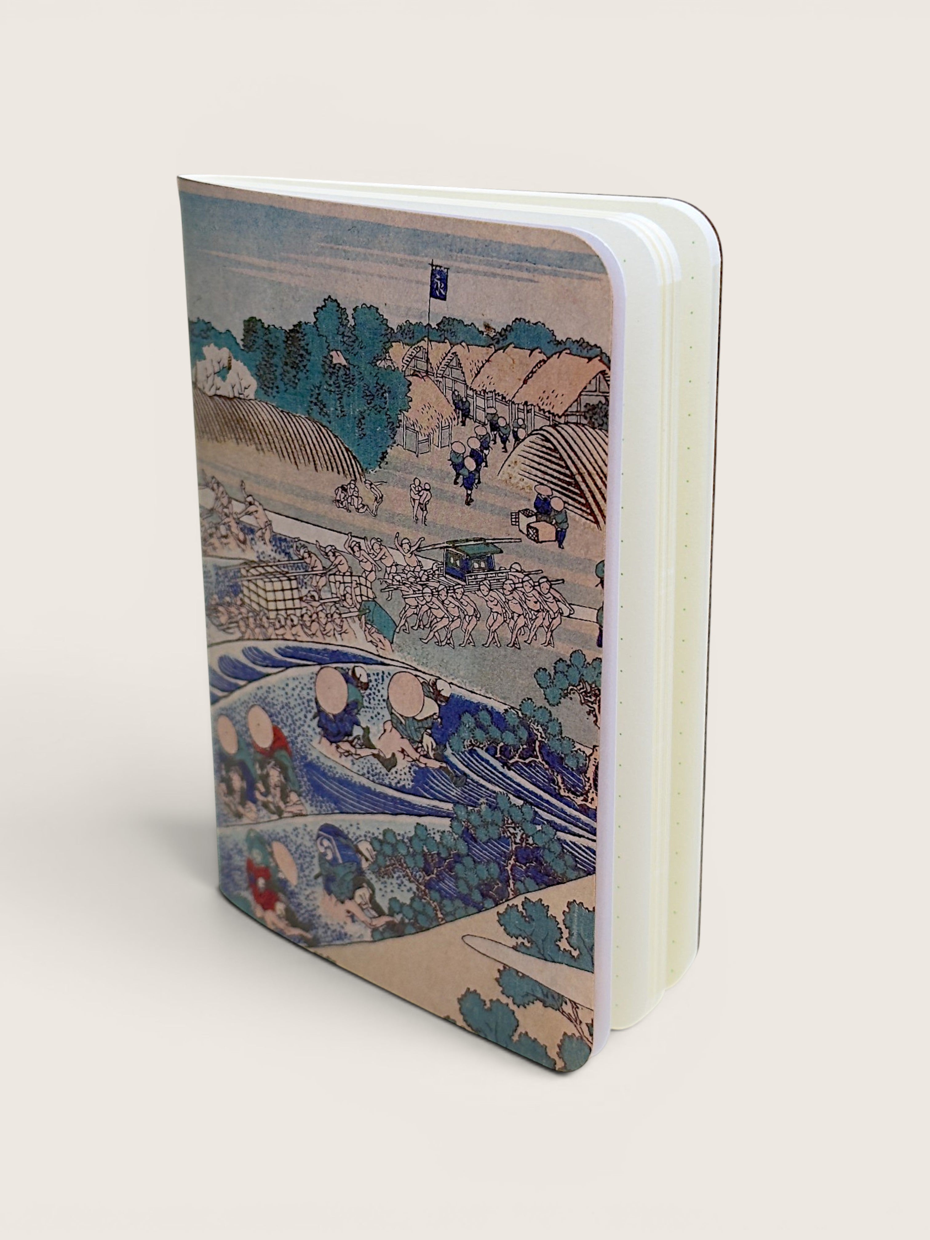 A hardcover notebook featuring a detailed Japanese ukiyo-e woodblock print on the cover, displayed at an angle on a light beige background.