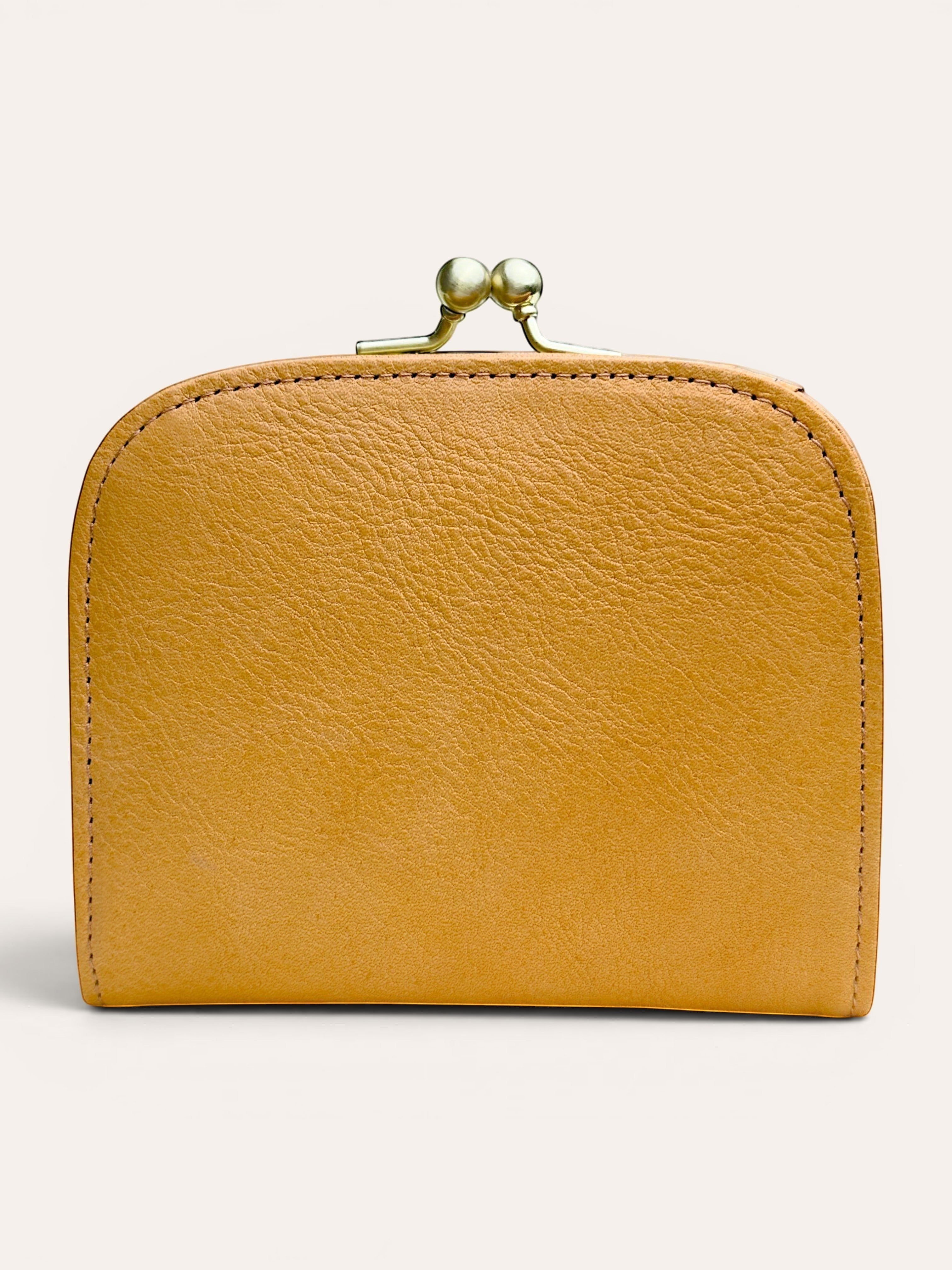 A small mustard yellow leather wallet with a gold-tone metal clasp closure, shown against a plain light beige background.