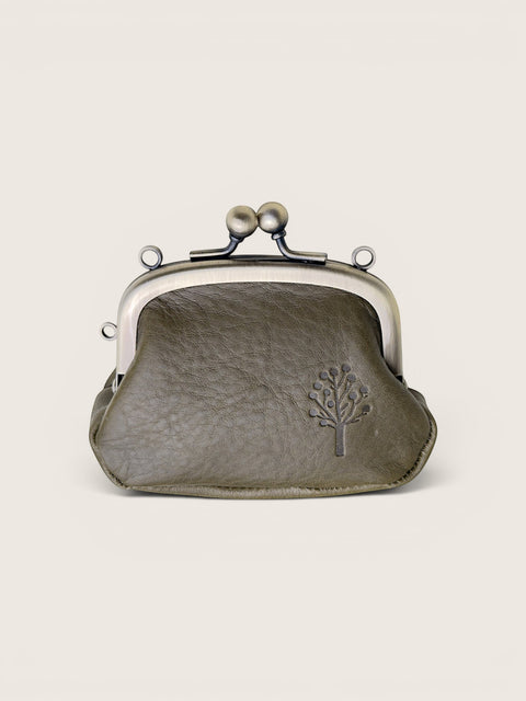 A small olive green kiss-lock purse with a textured leather finish, featuring a silver-tone metal frame and a debossed tree logo on the front, set against a solid off-white background.