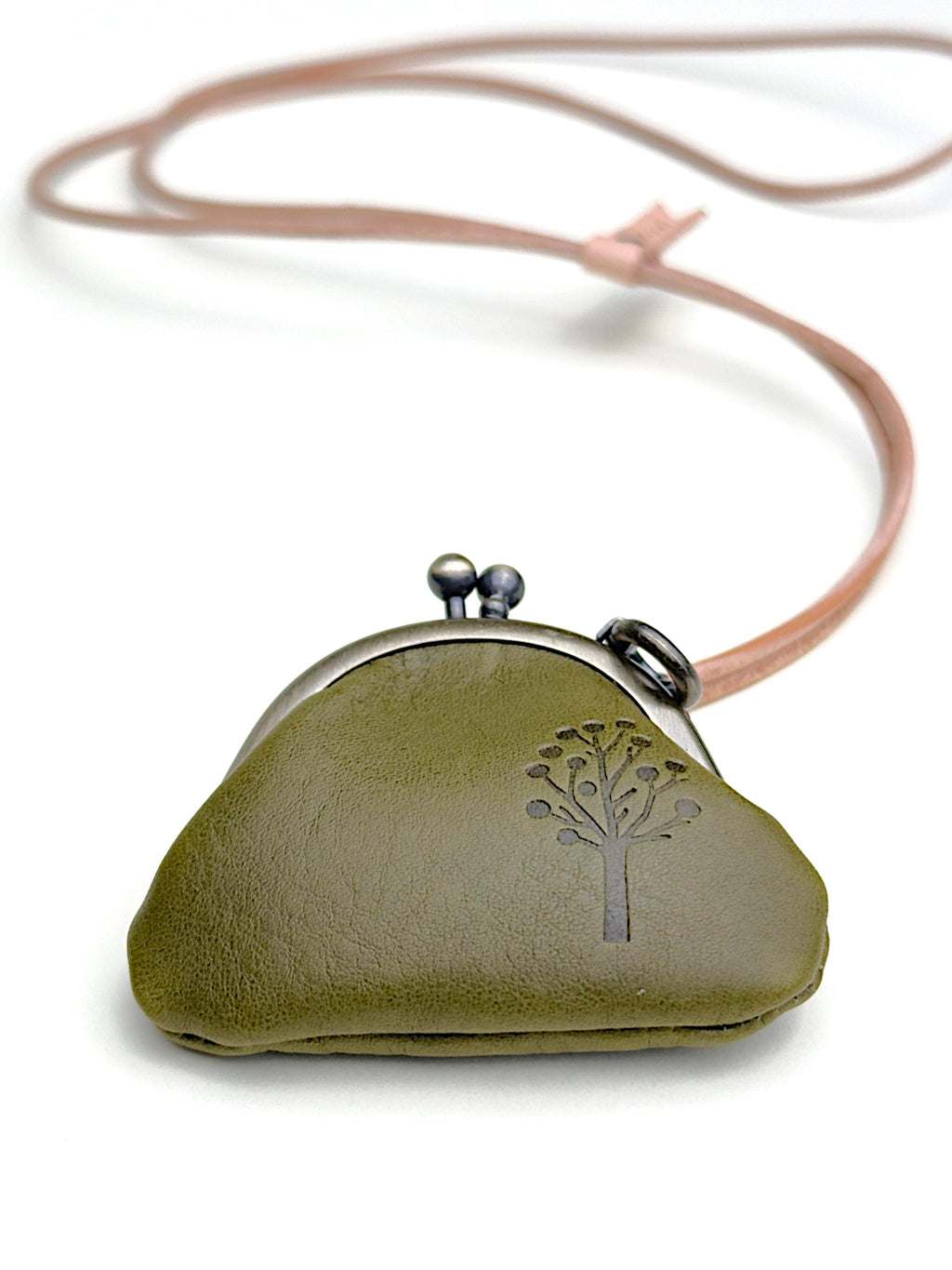 An olive green leather kiss-lock pouch with a tree design embossed on the front, attached to a thin dusty pink cord, shown on a white background.