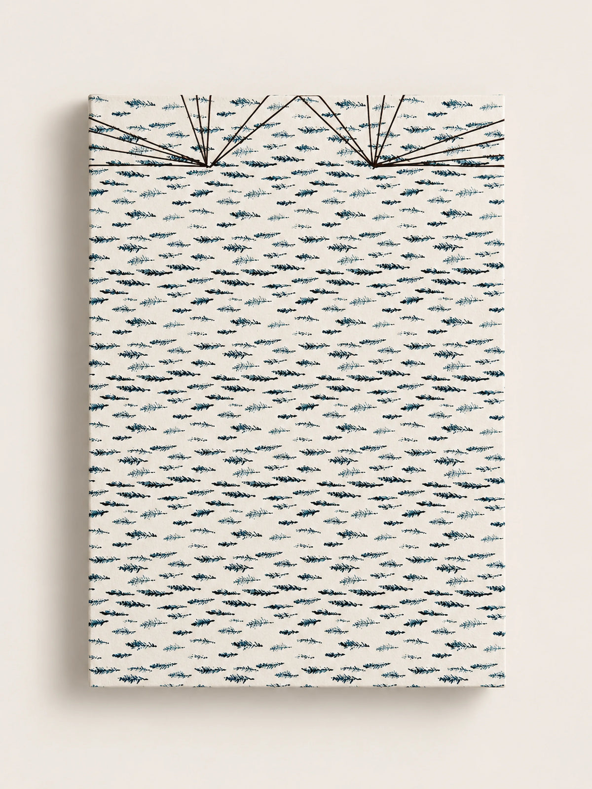 Cream handmade french journal cover printed with a repeating pattern of small dark blue and teal cypress sprigs, with fine black thread stitching fanning across the top edge