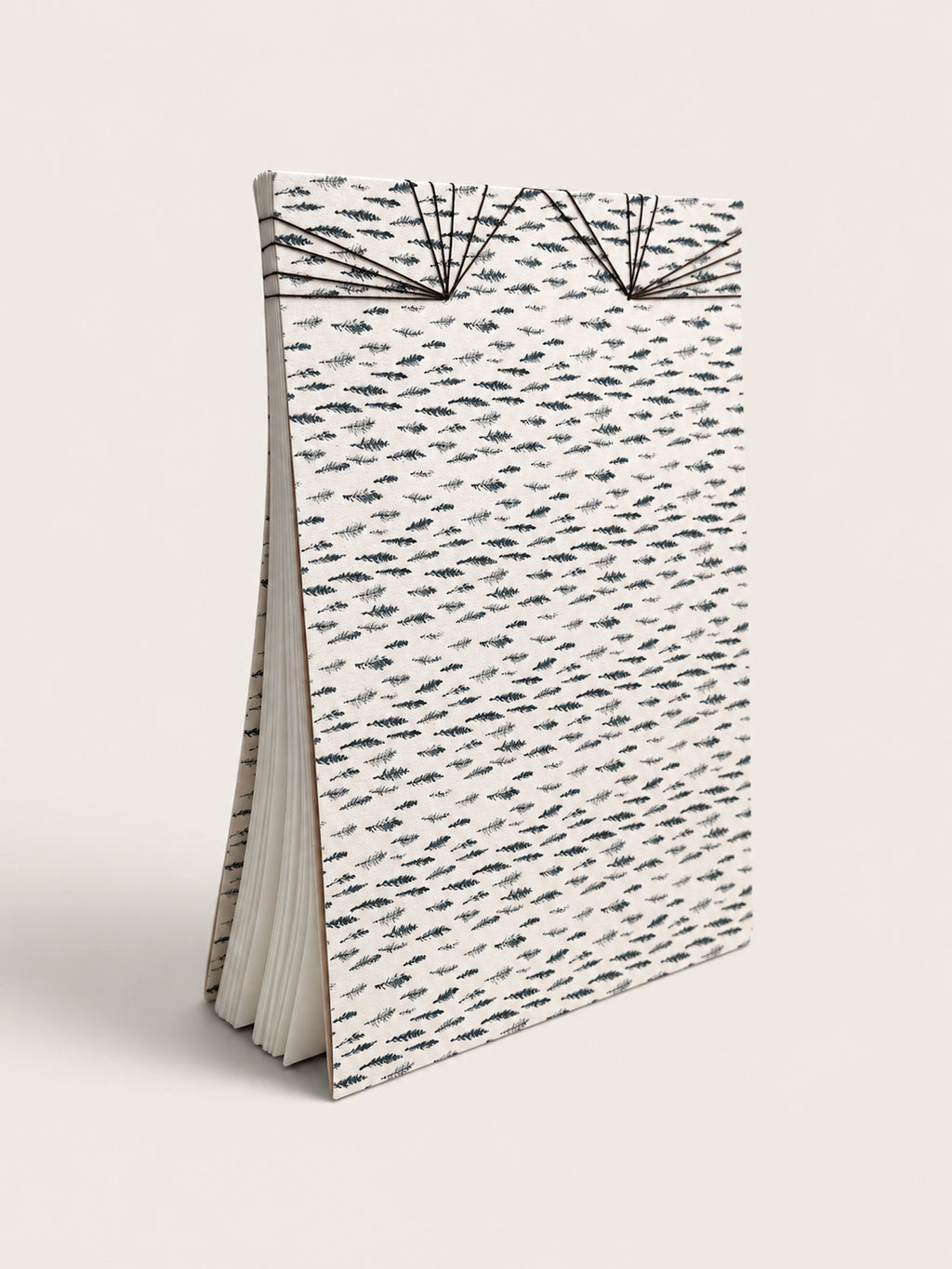 Ourooh A5 notebook featuring a white cover with black cypress sprig pattern and decorative Japanese-style fan binding. handmade by a french artist