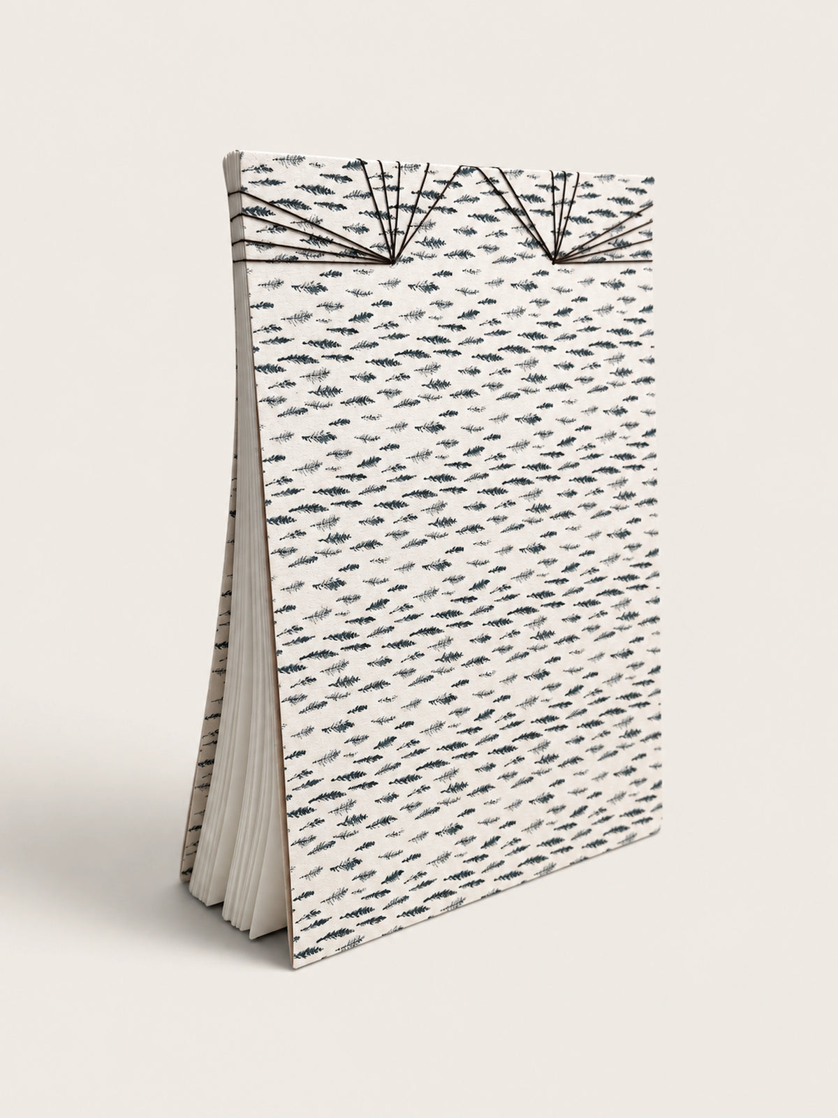 Ourooh A5 notebook featuring a white cover with black cypress sprig pattern and decorative Japanese-style fan binding. handmade by a french artist