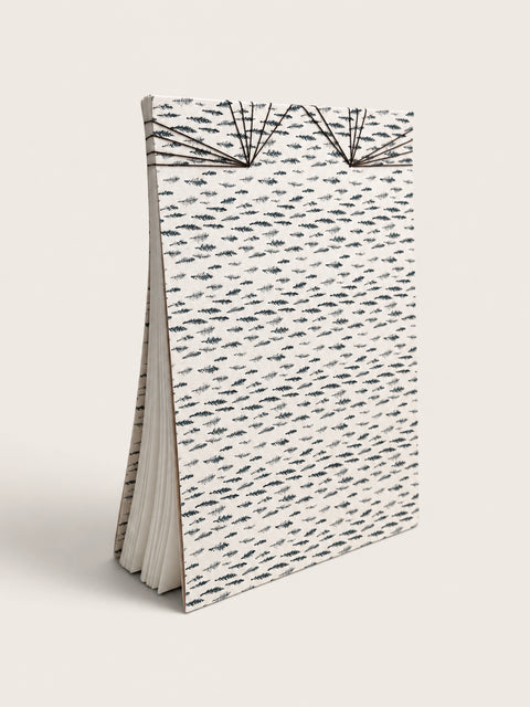 Ourooh A5 notebook featuring a white cover with black cypress sprig pattern and decorative Japanese-style fan binding. handmade by a french artist