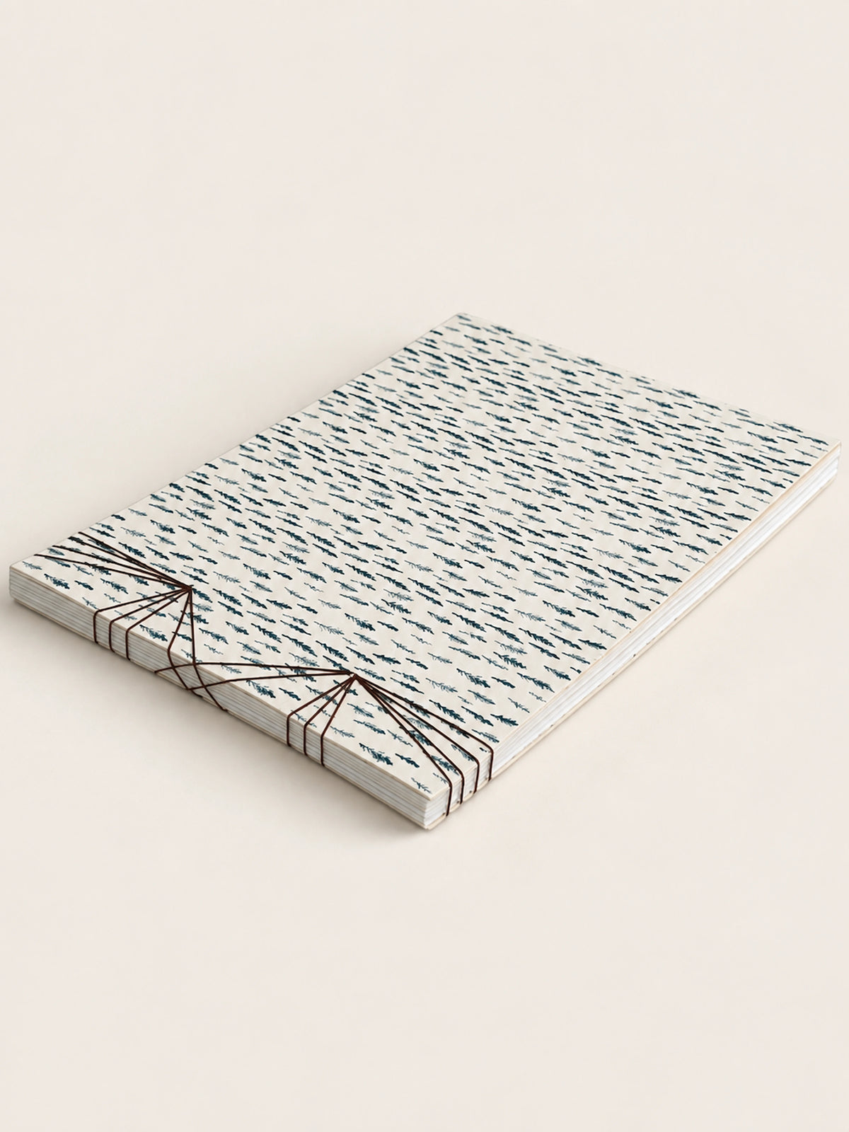 Black Cypress notebook lying flat at an angle, the stitching fanning across one end
