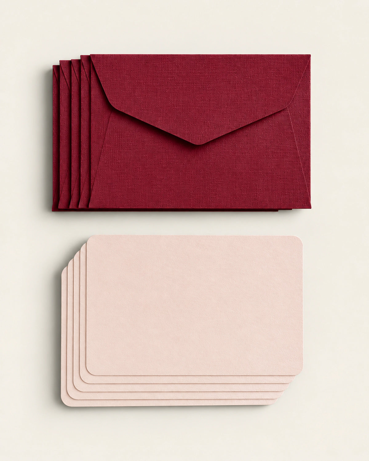 Five burgundy textured envelopes with five pale peach mini cards by Le Typographe