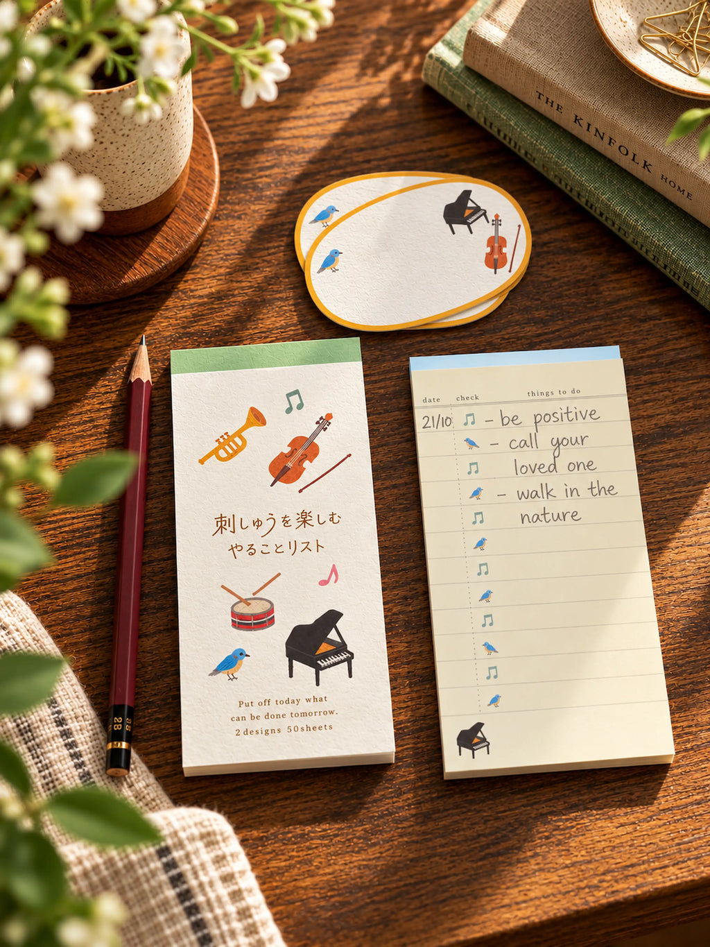 Japanese music-themed to-do list notepad with a textured illustrated cover, smooth lined writing sheets, piano, trumpet, cello and small birds.
