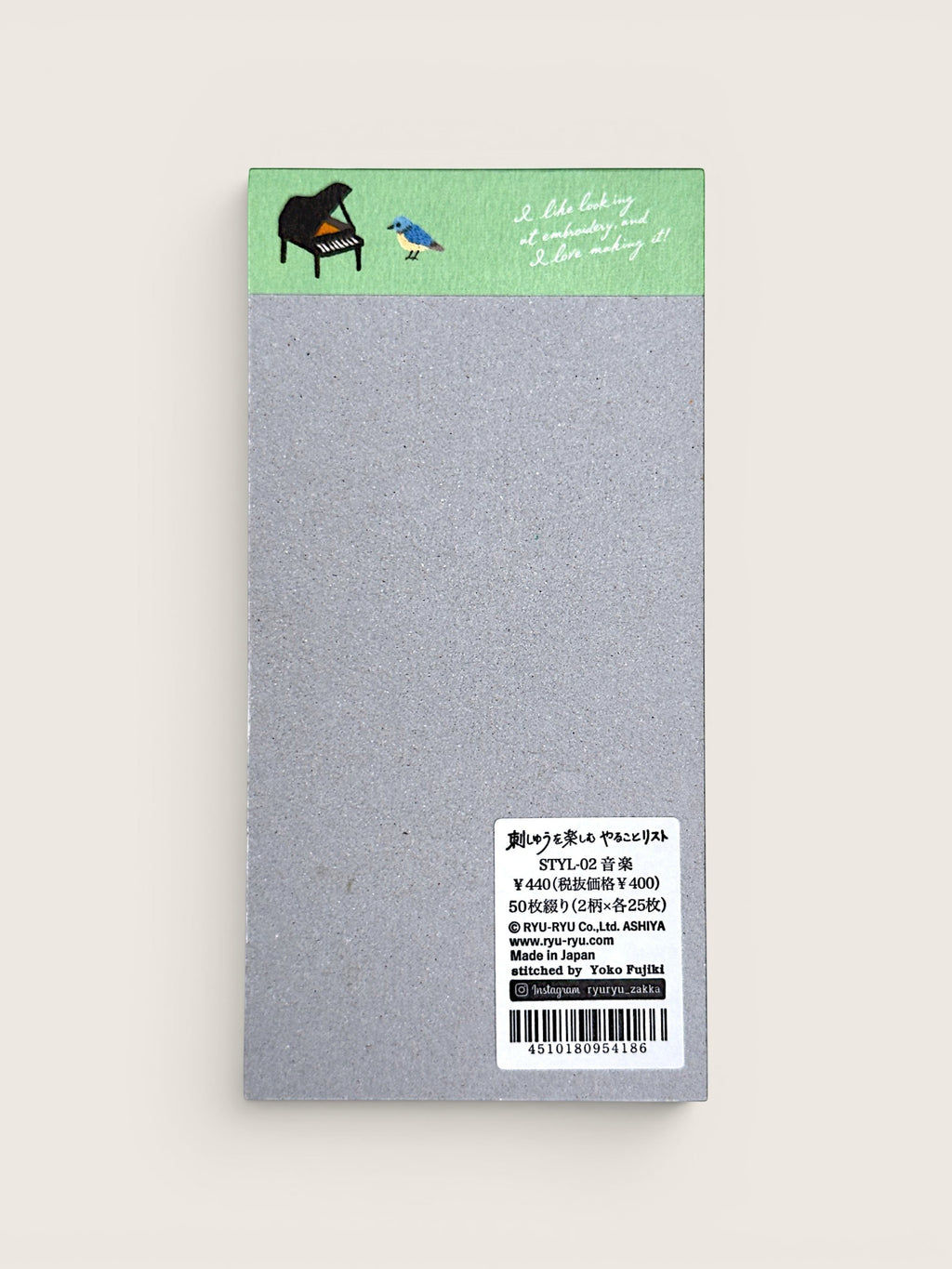 Ourooh Japanese to-do list pad featuring embroidered musical instrument illustrations and a blue bird on a green header.