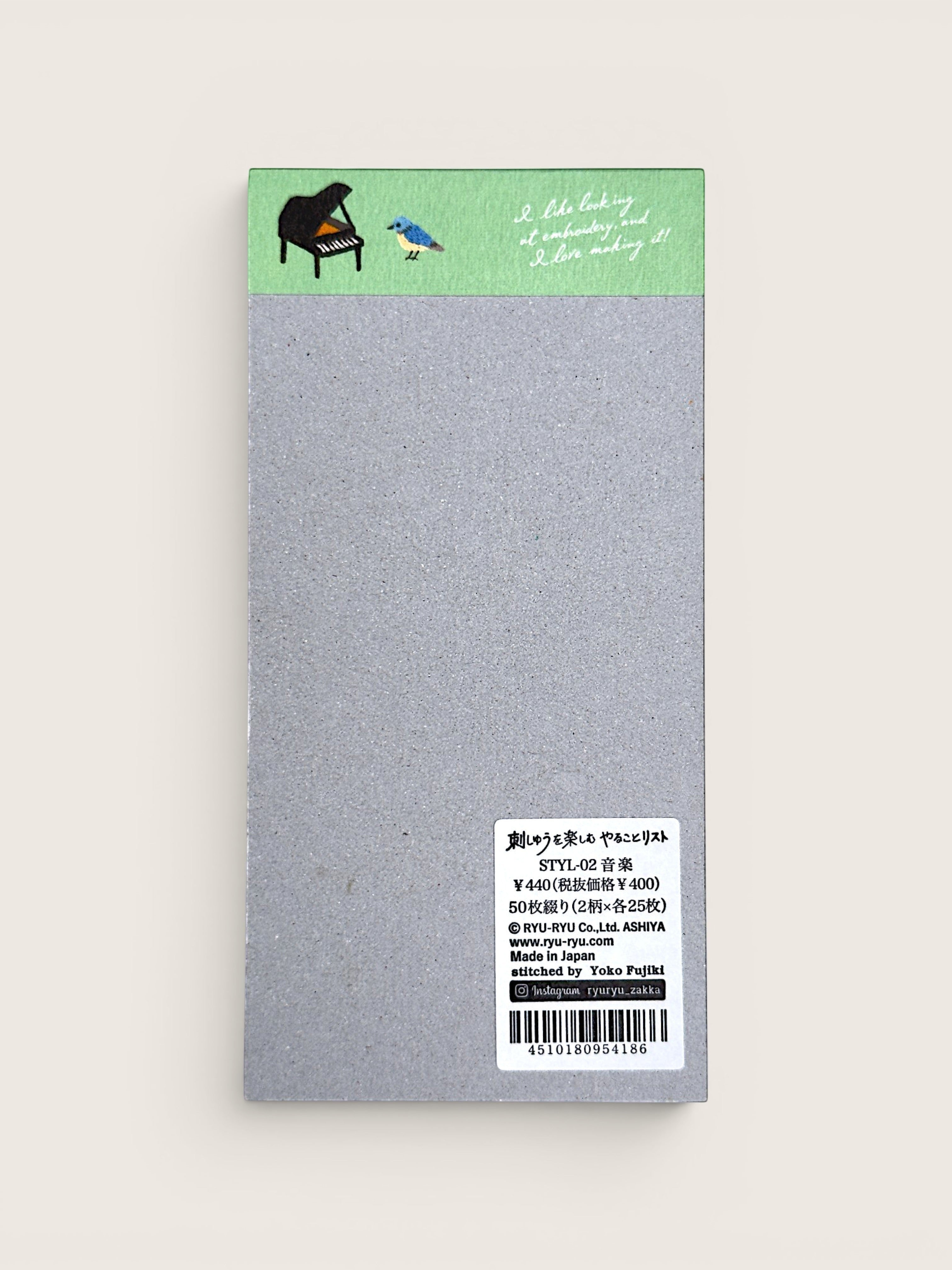 Ourooh Japanese to-do list pad featuring embroidered musical instrument illustrations and a blue bird on a green header.
