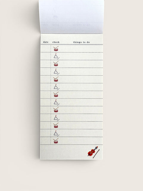 Ourooh Japanese to-do list pad featuring musical instrument illustrations, green top binding, and cream paper.