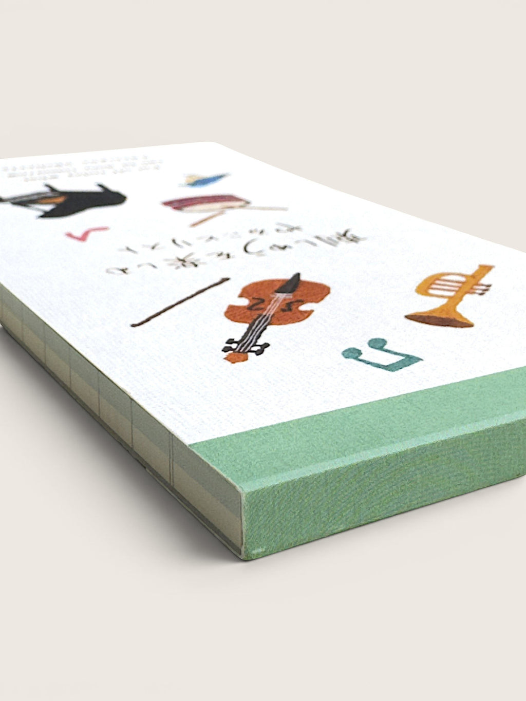 Ourooh Japanese to-do list pad featuring embroidered musical instrument illustrations and a green top binding.