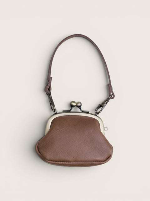 Ourooh Kanmi Japanese leather mini pouch with a brass gamaguchi clasp and adjustable strap in a rounded drop shape.