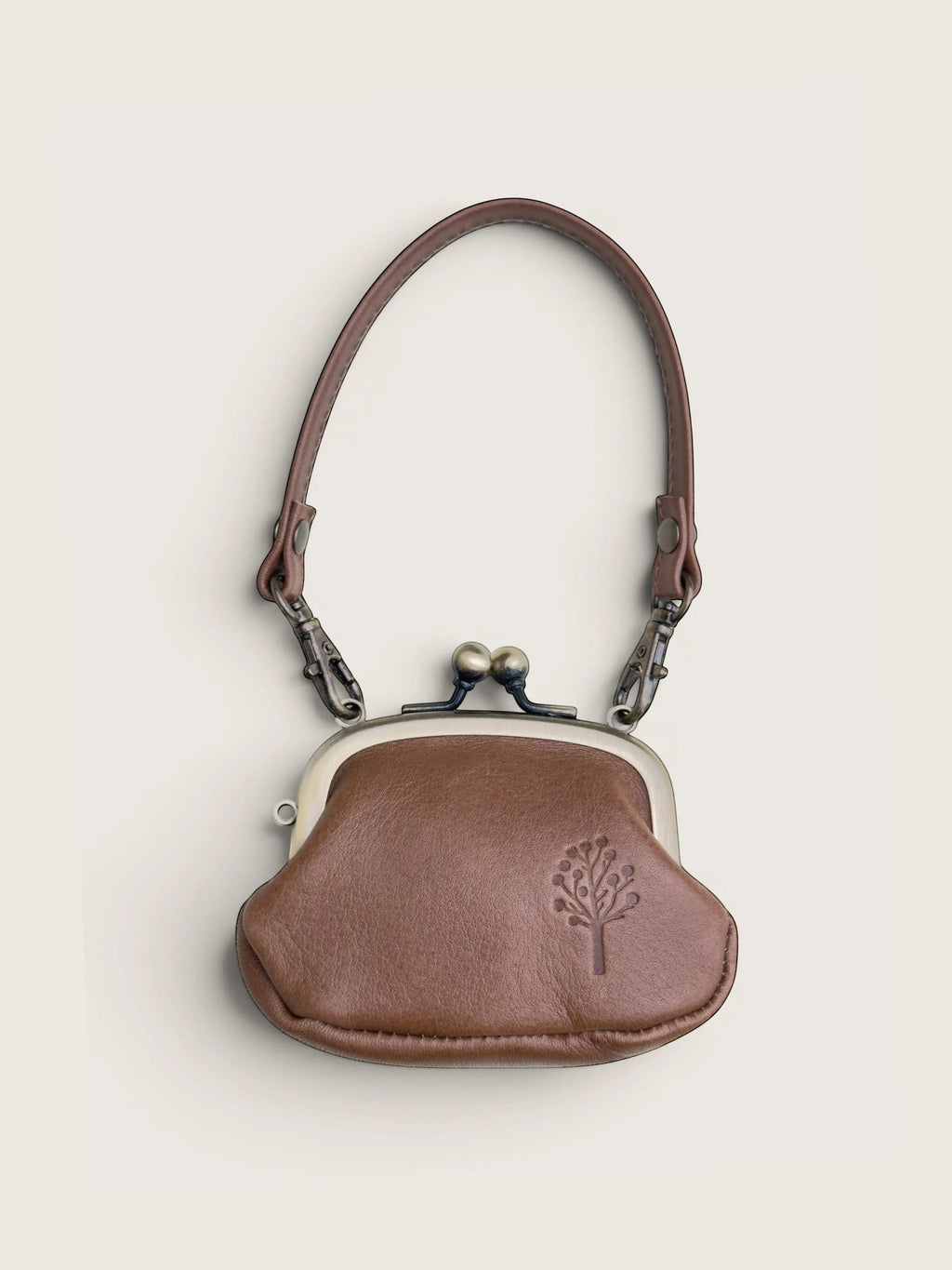 Ourooh Kanmi Japanese cowhide leather mini pouch with a gamaguchi clasp, adjustable strap, and embossed tree motif.