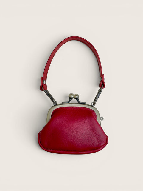 Ourooh Kanmi deep red Japanese cowhide leather mini pouch with a rounded shape, metal gamaguchi clasp, and strap.