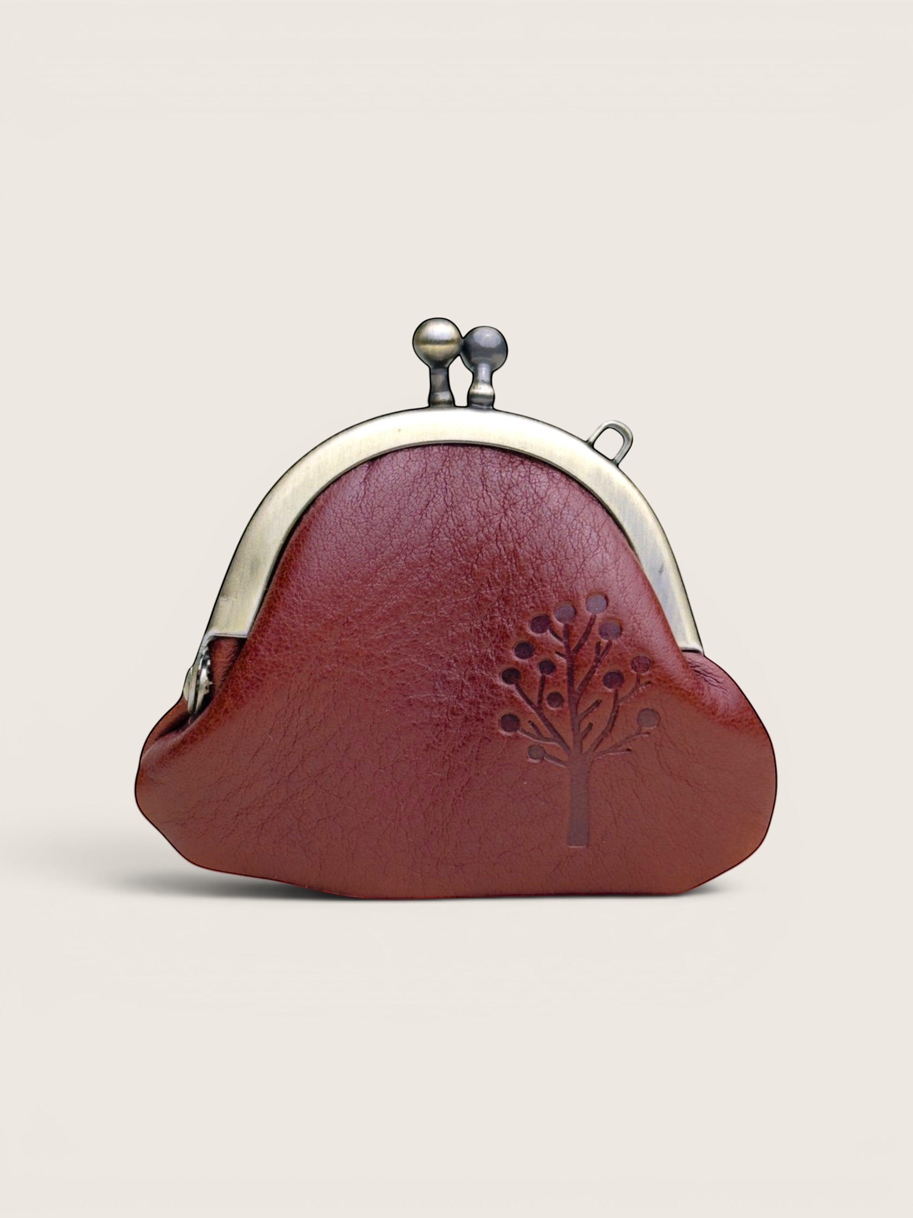 Ourooh Japanese leather gamaguchi necklace purse in reddish-brown with an embossed tree design and brass clasp.