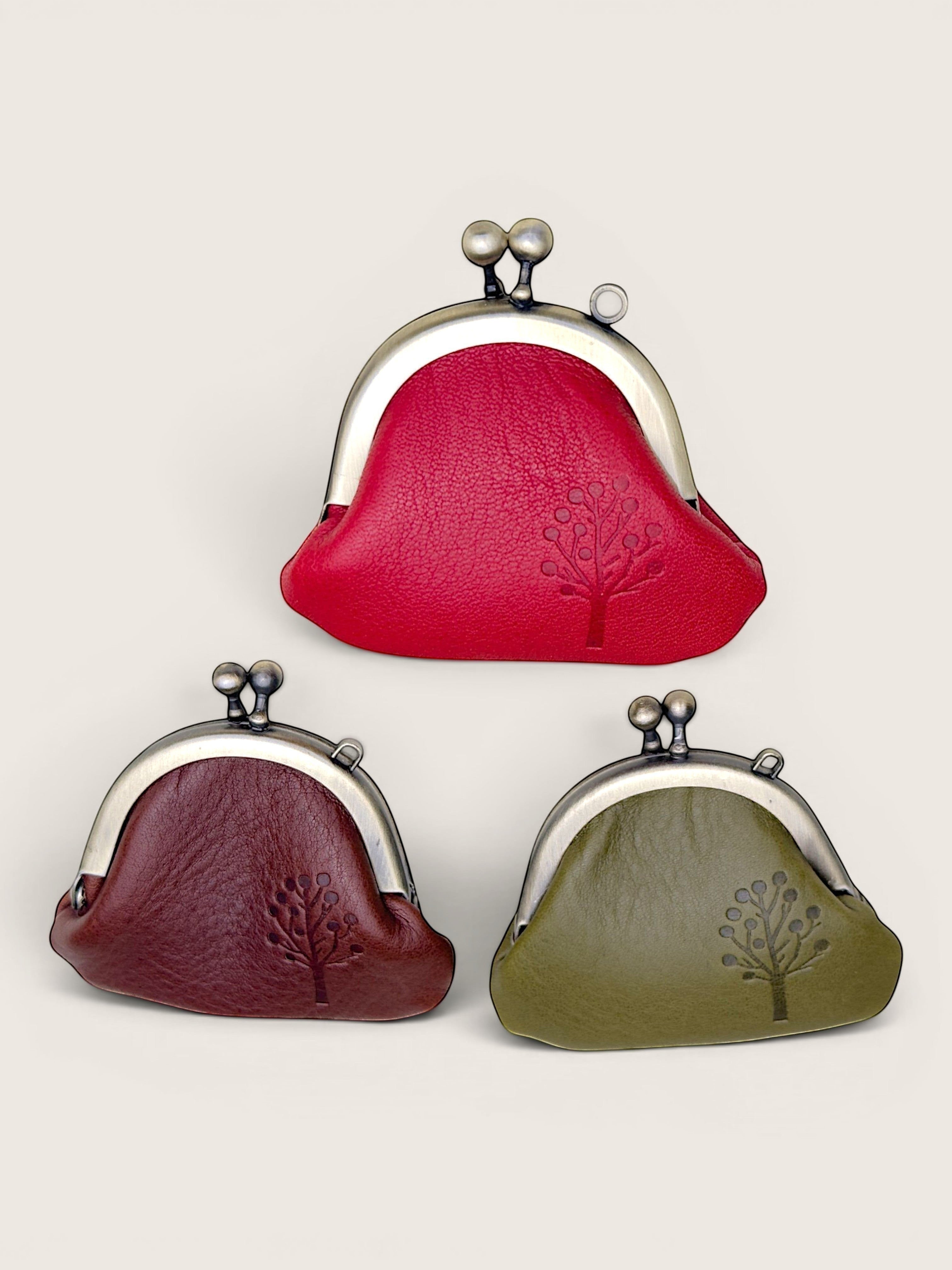 Ourooh Japanese leather gamaguchi purses in red, dark brown, and olive green with embossed tree detail and metal clasp.