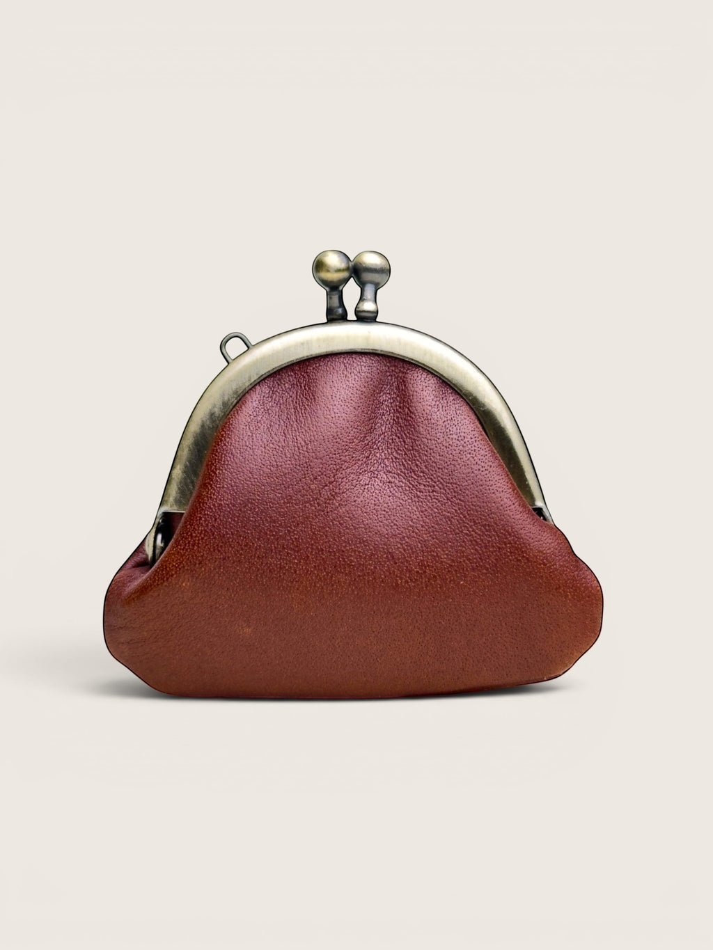 Ourooh Japanese leather gamaguchi necklace purse in deep red with a brass clasp and embossed tree detail.