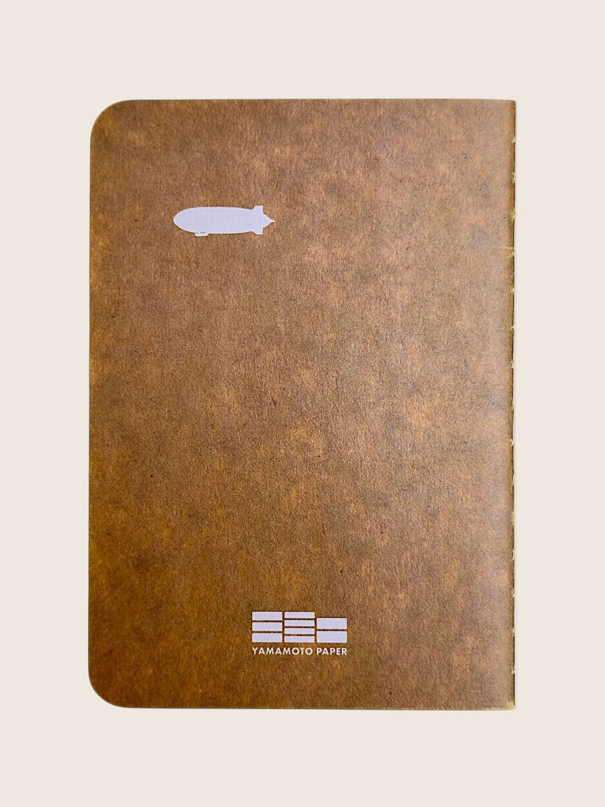 Back cover of the Lighthouse RO-BIKI notebook with a small white airship and the Yamamoto Paper mark.